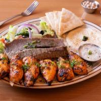 Gyros · Generous slices of seasoned lamb and beef slow grilled. Served with rice, hummus, Greek sala...