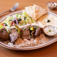 Filet Mignon Kabob · Marinated and spiced filet mignon cubes, grilled over fire. Served with rice, hummus, Greek ...