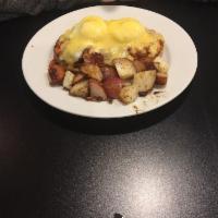 Classic Egg Benedict · 2 poached eggs, 2 slices of Canadian bacon atop of English muffins, and hollandaise sauce.