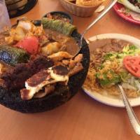 Molcajete · Steak, shrimp and chicken, onions, tomato, mushrooms and grilled cactus served on Mexican st...