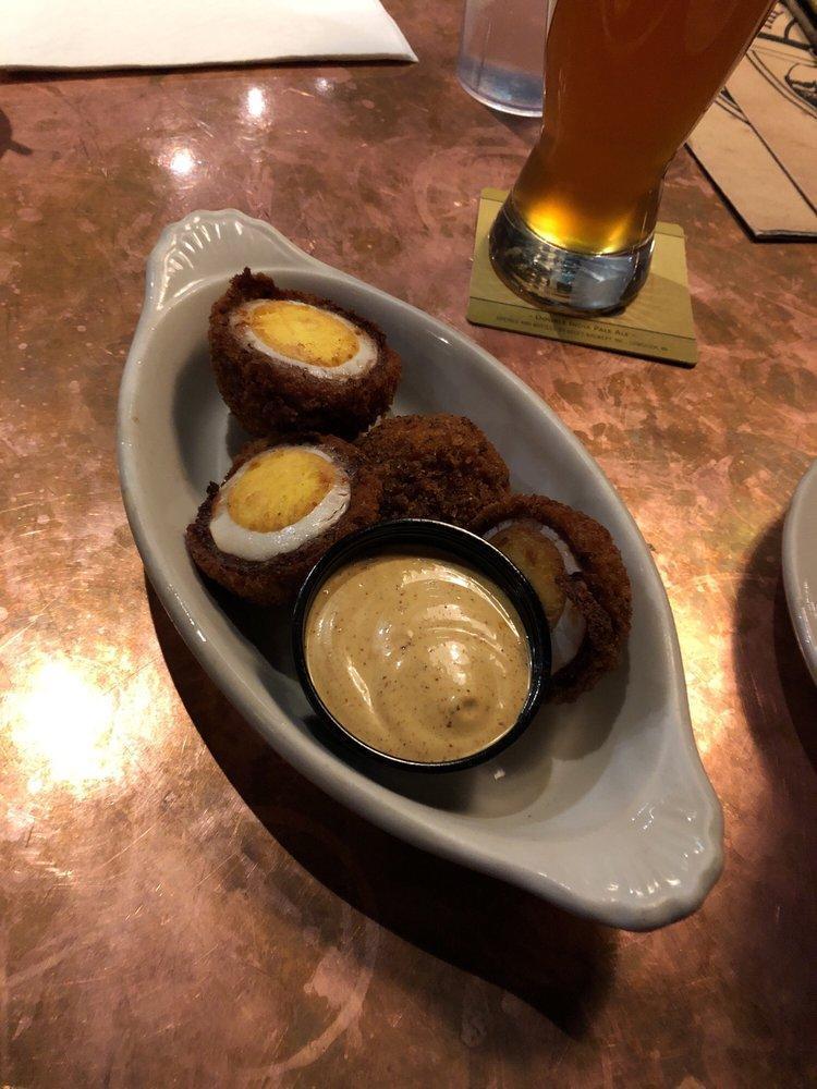 Scotch Eggs Plate · A pair of hard boiled eggs, wrapped in our house blended sausage, golden fried and served with our spicy mustard aioli.