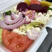 Greek Salad · Made with crisp lettuce feta cheese, tomatoes, black olives, cucumbers, beets, red onions, a...