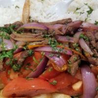 Lomo Saltado · Peruvian stir-fried beef with red onions, tomatoes, soy sauces and cilantro, served with ric...