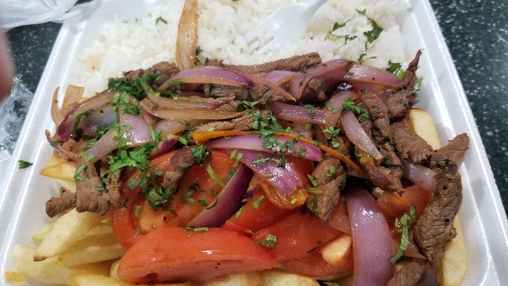 Lomo Saltado · Peruvian stir-fried beef with red onions, tomatoes, soy sauces and cilantro, served with rice and fries.