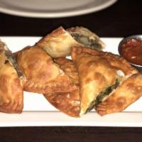 Empanadas · Savory fried pastry served with homemade sauce chicken or beef.