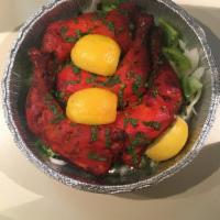 Tandoori Chicken · 3 chicken legs marinate in yogurt and spices then barbecued in our traditional clay oven.