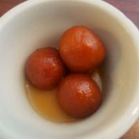 Gulab Jamun · Traditional sweet balls dipped in honey syrup with coconut.