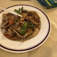 Drunken Noodles · Thick rice noodles cooked with egg, bamboo, onion, green bean, bell pepper, tomato, fresh ba...