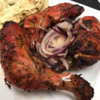 Tandoori Chicken · Chicken marinated in yogurt, ginger, garlic, spices and herbs overnight and cooked in a tand...