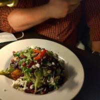 Brussels Sprout Salad · Arugula, dried blueberries, bacon, almonds, and manchego cheese tossed in lemon vinaigrette.