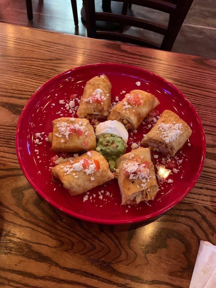 Chicken Taquitos · 2 rolled flour tortillas stuffed with chicken and mozzarella cheese, served crispy, garnished with tomatoes, queso fresco, guacamole and sour cream.