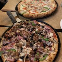 Monterey Chicken Pizza · Roasted chicken with red onions, green and red bell peppers and a creamy garlic sauce, toppe...