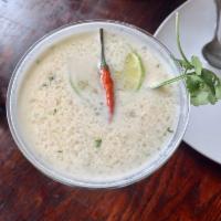 Tom Kha Soup · Galangal soup in silky coconut broth with lemongrass, mushrooms, onions, lime juice and kaff...