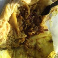 Curry Goat Roti - Wrapped · Serves wrapped, with goat, potato and chickpeas.