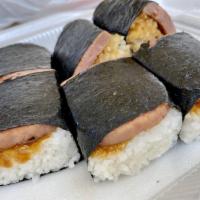 Spam Musubi · Ball of rice with seaweed and meat.