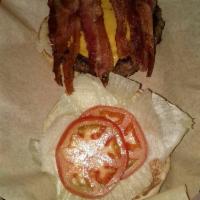 Big Daddy Burger · Two 1/2 lb. patties stacked with cheese, lettuce and tomatoes on a bun.