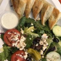 Spanakopita · 2 phyllo triangles stuffed with chopped spinach, onions, ricotta and feta cheese. Served wit...