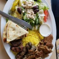 Sinbad's Mixed Grill Platter · Gyro slices, shish kabob and Kufta kabob. Served with basmati yellow rice, Greek salad, warm...
