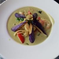 Green Curry · Green curry paste, bamboo shoots, Thai egg plants, bell pepper and basil leaves. Spicy.
