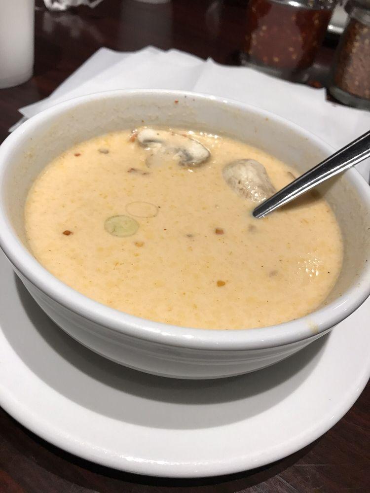 Thai Coconut Soup · Coconut milk broth with chicken, mushrooms, chilies, onions, scallions and cilantro.