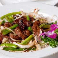 Mongolian Beef · Sliced tender beef seared with onions, scallions in special mongolian sauce. Spicy.