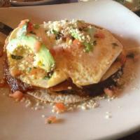 Huevos Rancheros · A quesadilla with chorizo sausage, Monterey Jack and refried black beans. Topped with two eg...