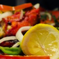 Tandoori Chicken · A barbecue delight, marinated overnight. Served with basmati rice. Served with basmati rice.
