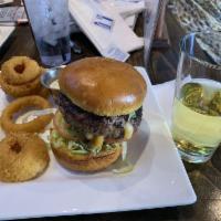 Juicy Lucy Burger · Cheddar-jack stuffed patty, lettuce, tomatoes and pickles.