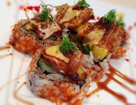 5 Piece Kiss of Fire Maki · Fried unagi, asparagus, mango topped with seared salmon, Japanese BBQ sauce a tobiko.