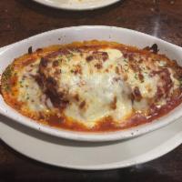 Parmigiana · seasoned chicken breast or Veal  topped with our traditional Marinara sauce and mozzarella c...