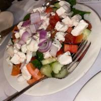 Chopped Salad · Over shad or romaine, diced tomato and cucumber, onion, mozzarella, finished in a red wine v...
