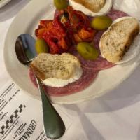 Antipasto · Homemade mozzarella, oven roasted sweet red peppers, Genoa salami, sicilian olives.
