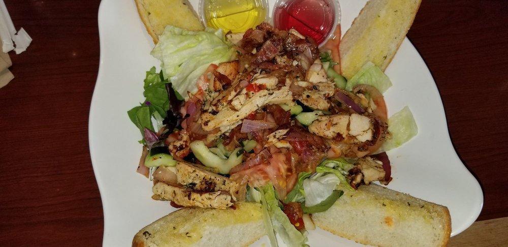 Tuscan Chicken Salad · Marinated chicken breast grilled with sweet peppers, bacon and onions, on a bed of mixed greens, tomatoes and cucumbers. Served with garlic bread.