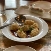 Wonton Dumplings · Shrimp and pork, chili oil, shallot, and cilantro.