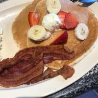 Sunrise Breakfast · 2 eggs any style, choice of ham, bacon, or sausage links, and 2 hot cakes topped with powder...