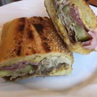 Cuban Sandwich · Mojo roasted pork, ham, pickles, Swiss, mustard, toasted bread.