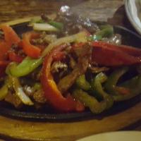 Steak Fajitas · Peppers, onions, guacamole, sour cream, rice and beans with warm tortillas.