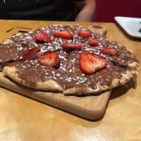 Fresa Y Chocolate Pizza · Small Nutella spread, topped with fresh strawberries, and a sprinkle of powdered sugar.