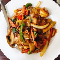 Drunken Noodles · Flat rice noodle sauteed with egg, chili, bell pepper, carrots, onions and basil.