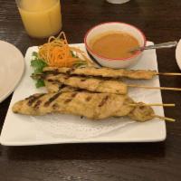 Chicken Satay · Chicken marinated in herbs, spices and coconut milk, grilled on skewers. Served with peanut ...
