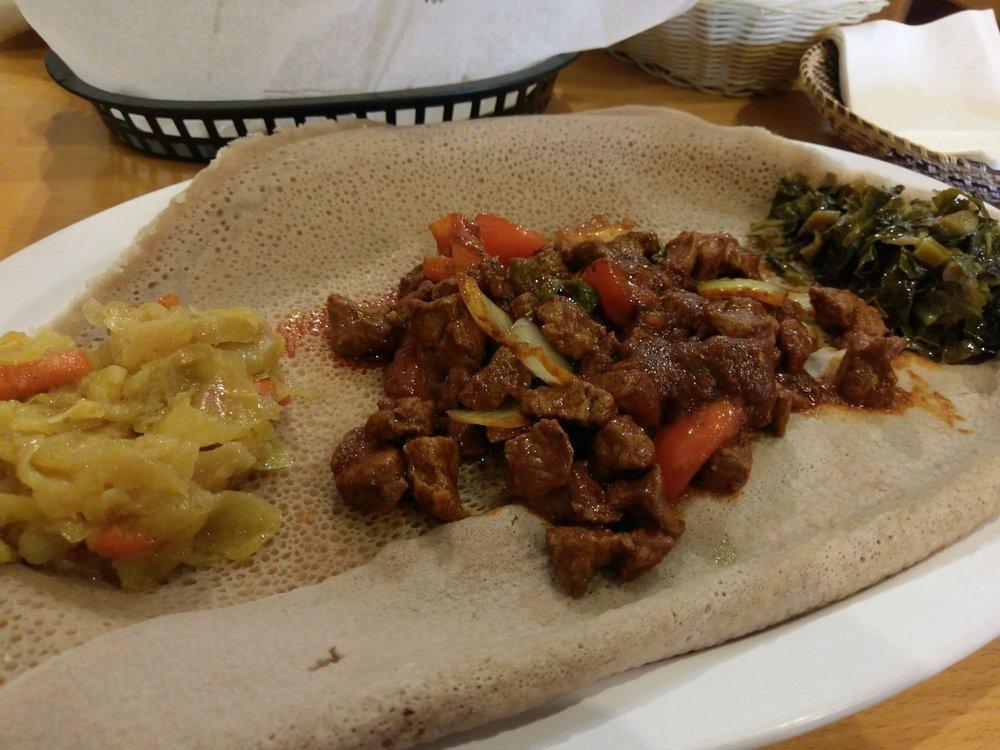 Lamb Tibs · Ethiopian's bread (injera). Lean lamb cubes sauteed with onion and jalapeno with two sides of veggie.