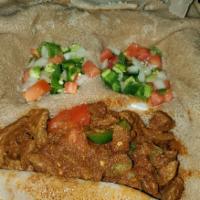Ahadu's Beef Tibs · Ethiopian's bread (injera). Lean cubes of beef sautéed with onion, tomato, and awaze (herbed...