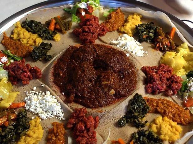 Beef Wot · Ethiopian's bread (injera). Cubes of beef simmered with berbere (red pepper and onion), with 2 sides of veggie.