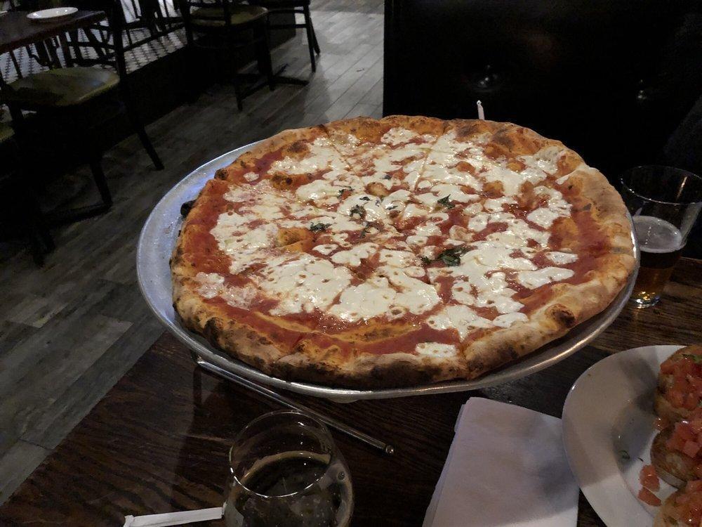 Margherita Pizza · Fresh mozzarella, tomato sauce and basil.