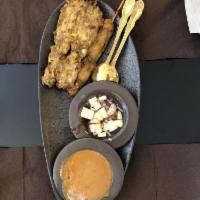 Chicken Satay · Thai chicken BBQ, grilled and served with homemade peanut sauce and cucumber salad.