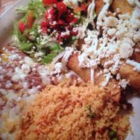 Flautas · 8 crispy chicken tacos with green tomatillo sauce, refried beans and sour cream. Ocho tacos ...
