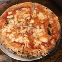 Margherita Pizza · Mozzarella, basil, extra virgin olive oil and Parmigiano-Reggiano.