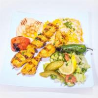 Chicken Kabab · Skewers of chicken mixed with onions and seasonings served with pickles, onion, tomato, lett...