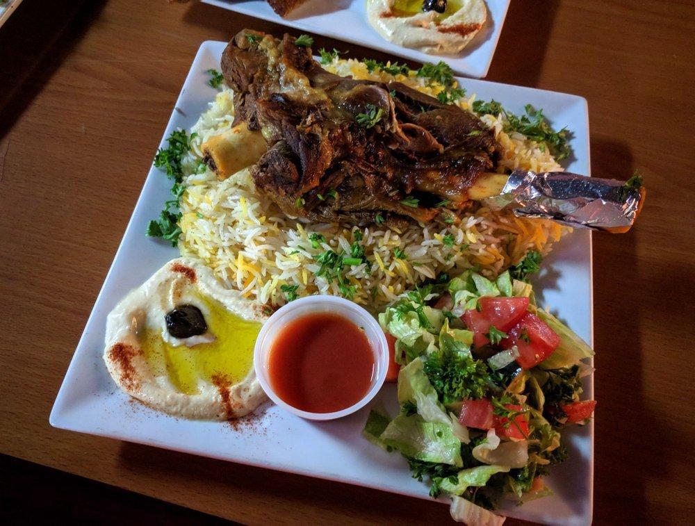 Lamb Shank · Lamb spiced in our secret seasoning, cooked to tender perfection, and served with basmati rice, hummus and salad. Served with rice, salad and appetizers.