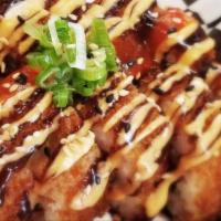 Dynamite Roll · Spicy tuna, cream cheese and jalapeno. Panko-fried and topped with spicy mayo, Sriracha, gre...